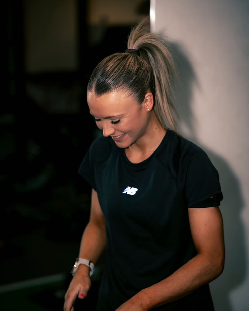 A physiotherapist in the gym during the intake conversation.